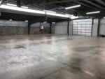 Steel building interior with concrete floor and walls